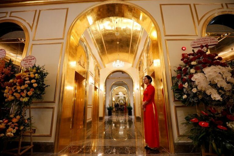 An employee in traditional dress is seen in the newly-inaugurated Dolce Hanoi Golden Lake luxury hotel