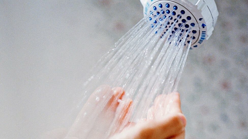 Hands under a shower head