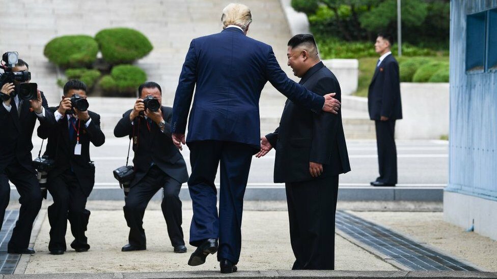 Mr Trump steps into the northern side of the military demarcation line dividing the two Koreas