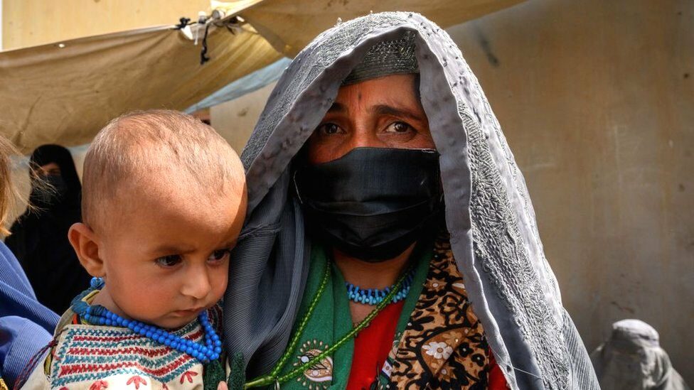 Image shows an Afghan woman in Helmand province earlier this year