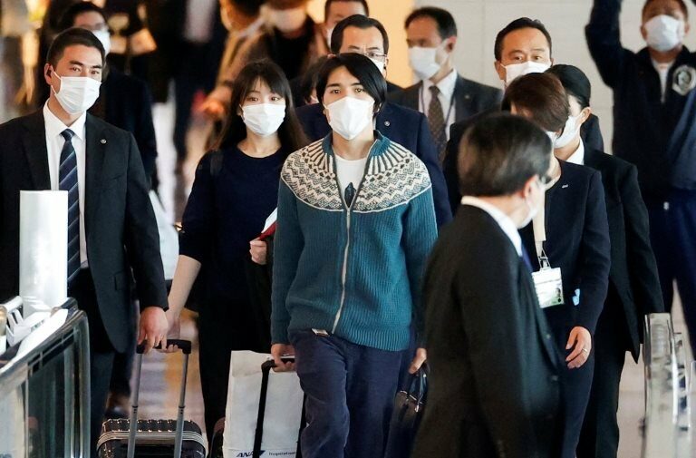 Mako Komuro, former Japan"s Princess Mako and the eldest daughter of Crown Prince Akishino and Crown Princess Kiko, and her newly married husband Kei board a flight bound for New York to start their new life in the U.S. at Haneda airport in Tokyo, Japan November 14, 2021.