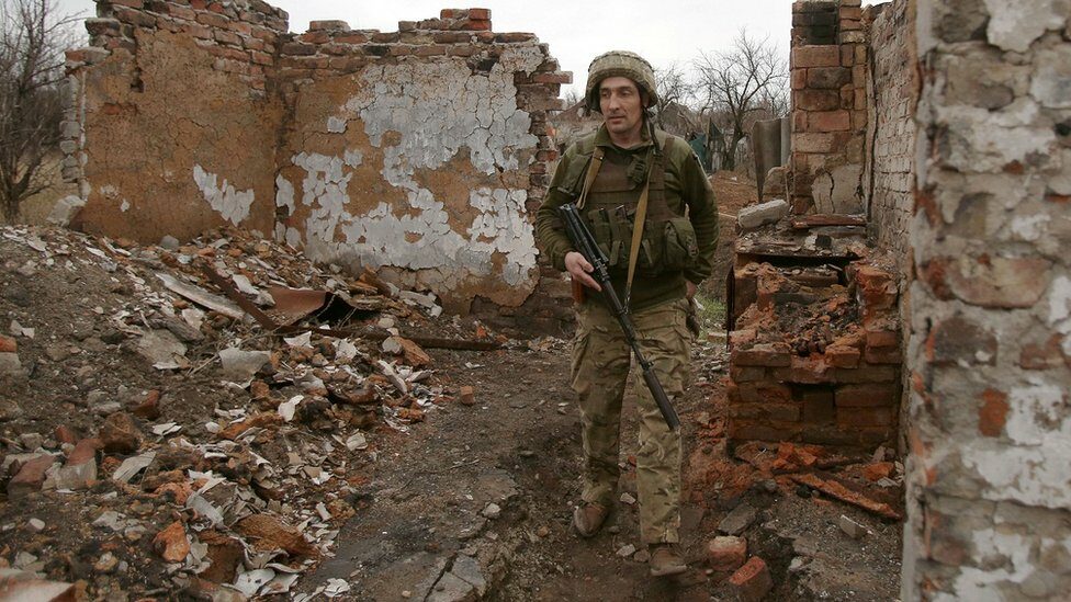 A Ukrainian serviceman patrols near the frontline with Russia backed separatists near small city of Marinka, Donetsk region. Photo: 12 April 2021