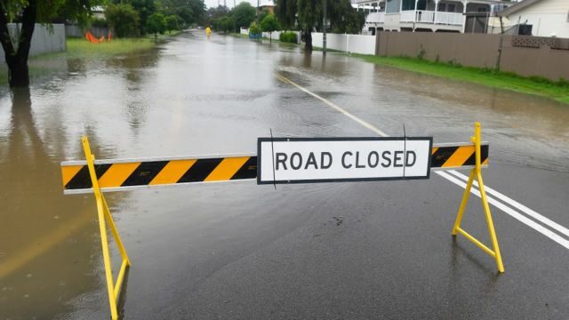 Warning sign on a flooded road in the suburb of Railway Estate on February 01, 2019 in Townsville, Australia. Queensland