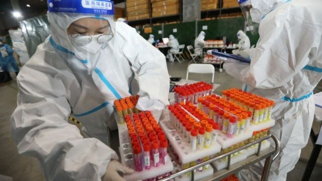 Medical workers wearing personal protective equipment (PPE) work on samples from local residents to be tested for COVID-19 at an air-inflated mobile COVID-19 test lab on December 27, 2021 in Xi an, Shaanxi Province of China.