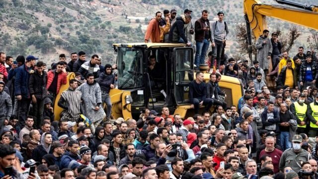 People watch as Moroccan emergency services teams work on the rescue of five-year-old boy Rayan from a well shaft he fell into on 1 February